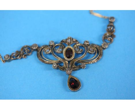 A 14 ct gold ruby and diamond pendant with gold chain.
