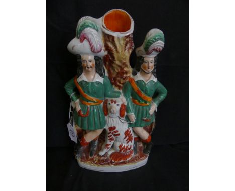 A 19th Century Staffordshire figural spill vaseFormed as two Scottish gentleman and a Spaniel by a tree trunk, raised on an o