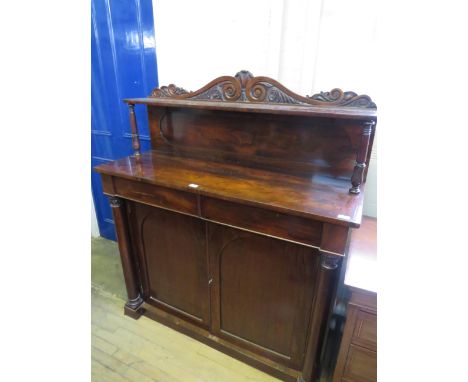 An early Victorian rosewood chiffonierWith arched back section with single shelf and carved detail over a base with two drawe