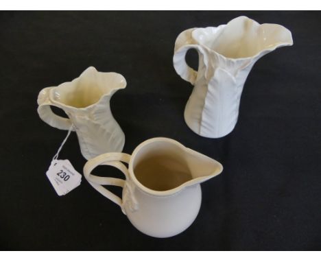 A Leeds Pottery jug, with entwined handle, together with two Royal Worcester leaf formed jugs, largest piece height 12.5cm (3