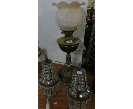 A mixed lot comprising a brass oil lamp with opaque glass shade, a clear glass decanter and pair of table lamps with clear pr