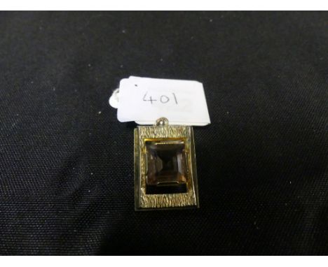 A 1970s orange paste pendantThe square shape orange paste within a rectangular shape textured surround, stamped 14ct, length 