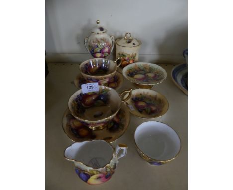 A collection of Aynsley Orchard Gold china wares comprising two cups and saucers, small double handled vase, covered jar, ped