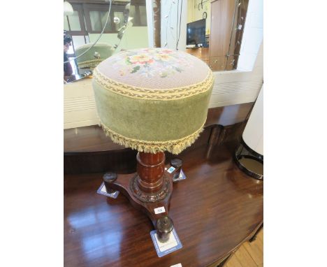 A Victorian revolving piano stoolWith tapestry covered seat over a turned column and three footed base, height 60cm 