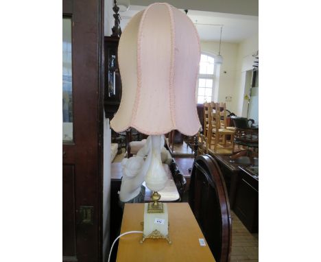 A modern gilt metal mounted onyx table lamp raised upon paw feet 