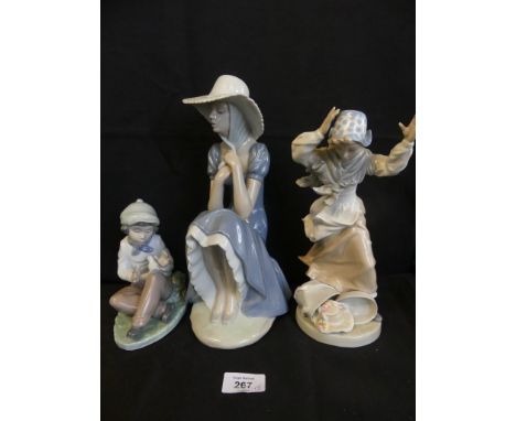 A group of three various Nao figures, Boy with bird, Seated young lady and lady on a windy day (3) 