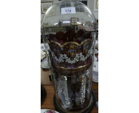 A Victorian ruby glass lustre vaseDecorated with enamel floral and gilt detail, fitted with cut clear glass prismatic drapes,