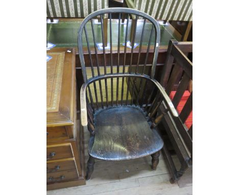 A 19th Century and elm and alder wood hoop back Windsor farmhouse elbow chair with a stick back above a shaped seat. 