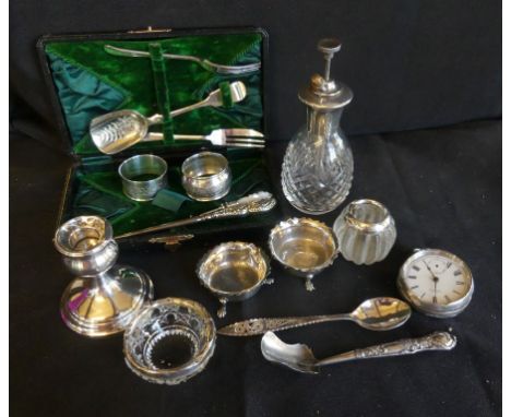 A mixed lot various silver wares to include silver cased American pocket watch, various napkin rings, dressing table candlest