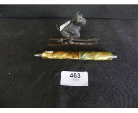 A vintage Parker fountain pen and a Black Forest type wooden model of a skiing dog 