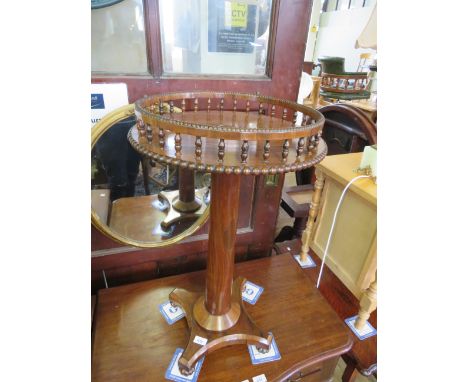 A mid 19th Century rosewood pedestal lamp table with circular top and a spindled gallery 