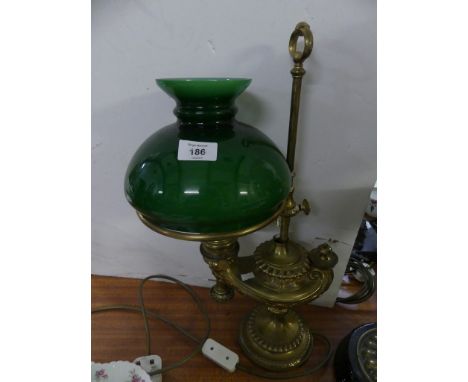 An usual brass former oil lamp formed as an Aladdin's lantern, fitted with a green vesta glass shade