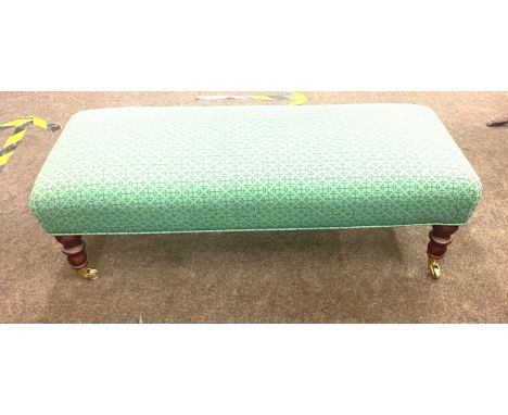Long low foot stool on casters measures approx 13" tall 42.5" wide 18" depth 