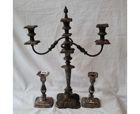 Three light candleabrum and a pair of candlesticks.