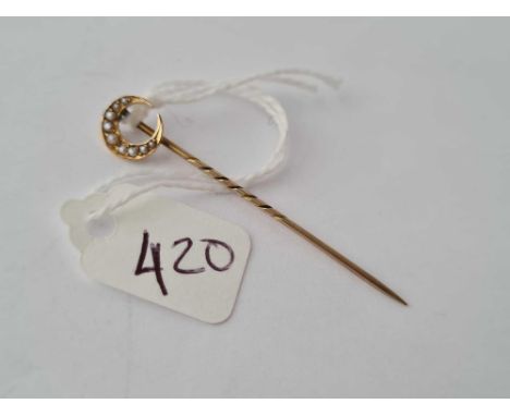 A pearl crescent topped stick pin in 9ct 