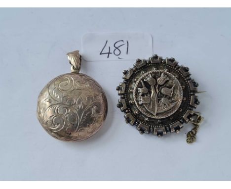 A vintage silver locket and silver brooch