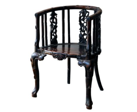 AN EARLY 20TH CENTURY CHINESE CARVED HARDWOOD CHAIR. With horseshoe-shaped back carved to simulate bamboo and pierced with vi