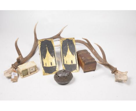 A mixed group of collectable itemsTo include a pair of unmounted stag antlers, a carved coconut lidded box, a pair of gilt an