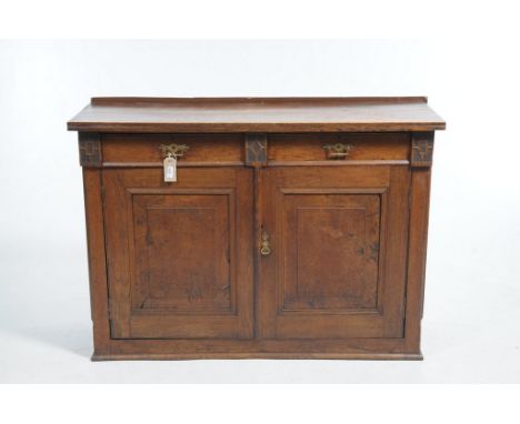 A Late Victorian oak and pollard oak side cabinet With two frieze drawers over a pair of pollard oak panelled cupboard doors,