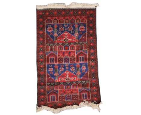 A Qashqai style rug On a predominantly ruby red ground, the central field with varying geometric patterns and foliate design,