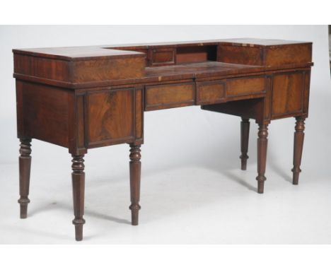 A Regency style mahogany sideboardThe raised back centred with a leafy crest above a rectangular moulded top with a beaded bo