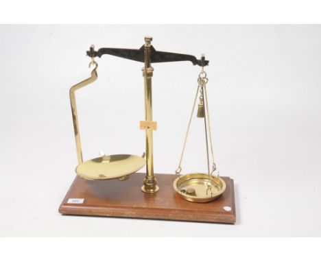 A Leicester Scale Company Ltd set of brass weighing scalesRaised on a wooden plinth base, with central brass stem and twin we