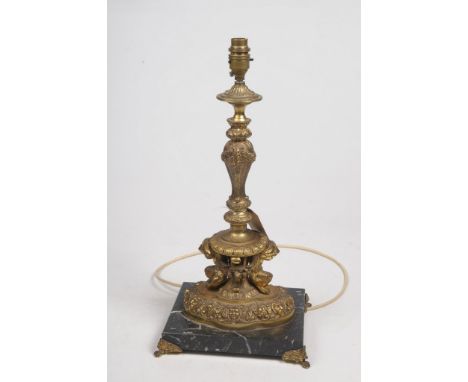 A French Rococo style gilt metal and black marble lamp base.Of rectangular form raised on four swept gilt ball supports, the 