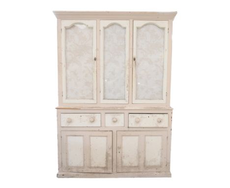 A Late Victorian painted pine housekeepers cupboardWith a cavetto cornice above three glazed doors , the base with an arrange