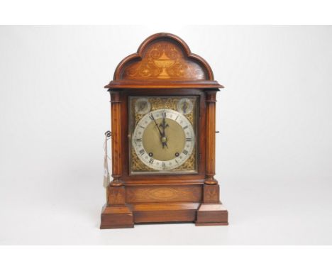 An Edwardian Inlaid Oak and Satinwood eight day Chiming mantel clockThe architectural case, with scalloped domed pediment, ri