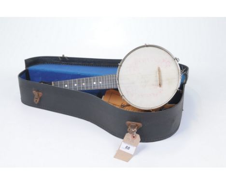 A Ukulele-Banjo, mid 20th CenturyOf typical form the four string instrument with stained wooden outer frame, housed in origin