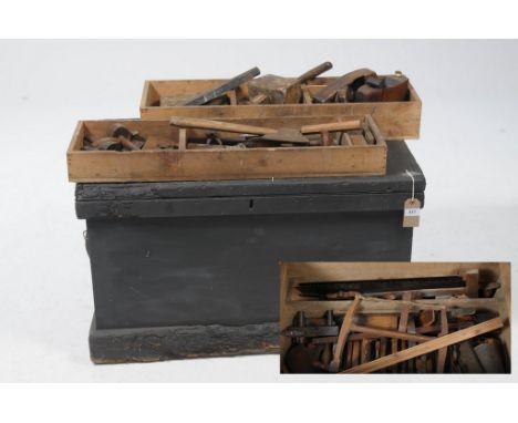 A collection of 19th century and later toolsHoused in a black painted pine tool chest comprising various wood working planes,