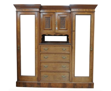 A good quality Edwardian oak and Pollard Oak compactum wardrobe by Maple & Co.With an inverted break front dentil cornice abo