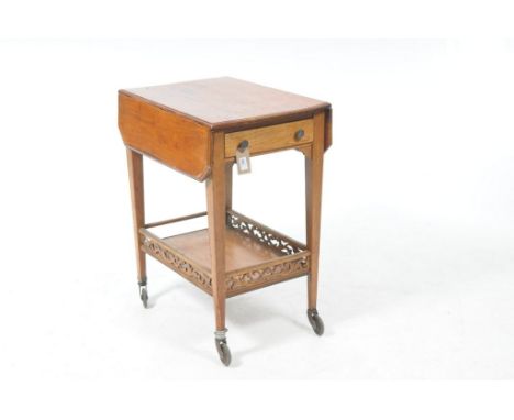 An unusual 20th Century walnut drop leaf serving trolleyWith a single frieze drawer and a galleried under shelf, 62x80x44cms