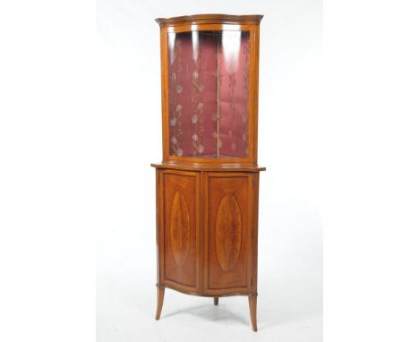 A Fine quality serpentine satinwood Edwardian freestanding corner display cabinetWith a single serpentine glazed door enclosi