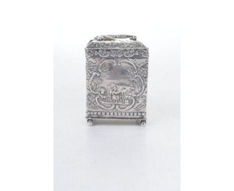 An early 20th century Dutch silver tea caddyThe rectangular caddy with embossed country life scenes and cherubs, the hinged c