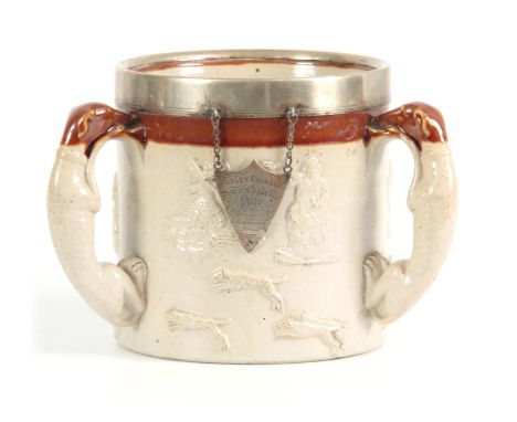 AN OVERSIZED DERBYSHIRE SALT GLAZED STONEWARE HUNTING TYG the buff ground with a wide treacle glazed border and nickel mounte