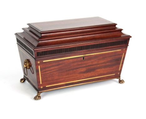 A REGENCY BRASS INLAID MAHOGANY SARCOPHAGUS SHAPED TEA CADDY with reeded frieze and lions paw feet (interior missing) 37cm wi
