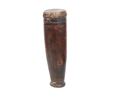 A 19TH CENTURY AFRICAN DRUM with goats skin top on a hollowed trunk wooden base 103cm high.