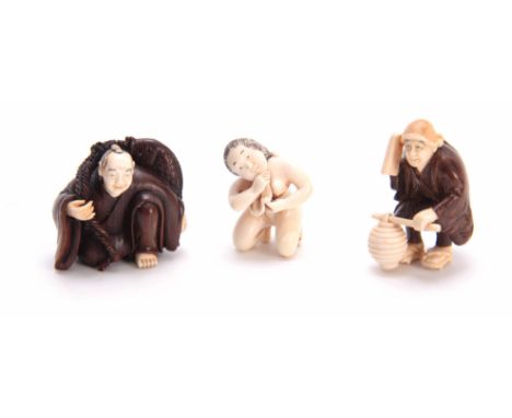 A COLLECTION OF THREE EARLY 20th CENTURY IVORY AND HARDWOOD NETSUKE sculptured as various figures all with character marks (3