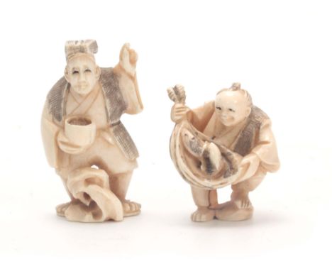 A PAIR OF JAPANESE IVORY NETSUKE one modelled as a man holding his catch of fish, the other holding a bowl of food, both wear