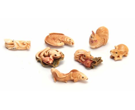 A COLLECTION OF SEVEN EARLY 20TH CENTURY IVORY NETSUKE sculptured as rabbits, fish, hen, and octopus all with character marks