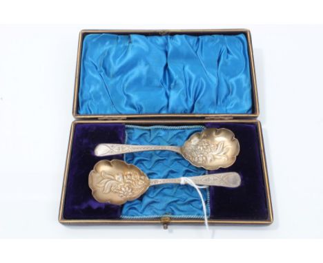 Pair late Victorian silver preserve spoons with embossed floral bowls and bright cut stems, in a fitted case (Birmingham 1895