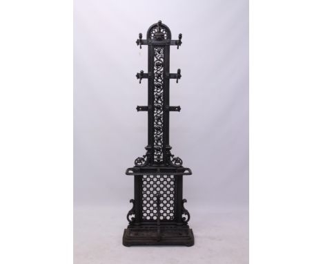 Victorian cast iron hall stand with pierced mask and floral scroll bar back and four projecting scroll arms with stick stand 