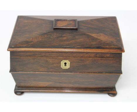 William IV Regency rosewood tea caddy with faceted hinged cover enclosing fitted interior with twin lidded compartments flank