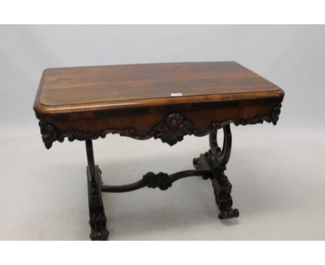 William IV rosewood card table with hinged rounded rectangular moulded top on shaped frieze and pierced lyre shaped ends and 