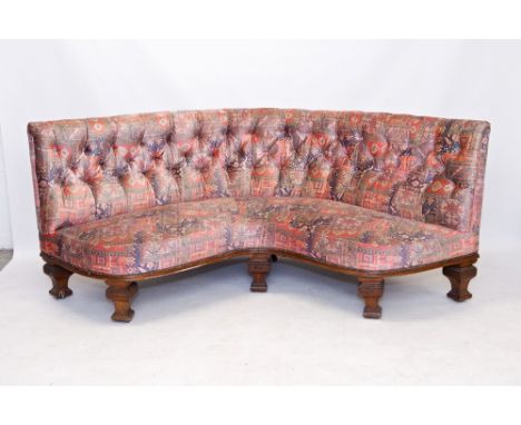 HM Queen Victoria - a Royal sofa of curved corner form, with buttoned turkey-pattern upholstery, with oak frame with square t