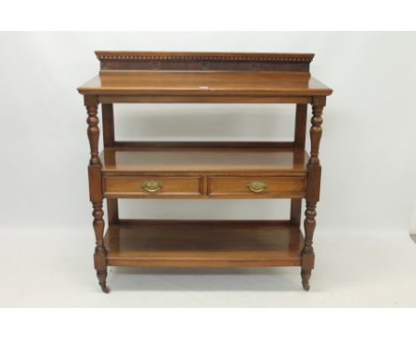 Good quality late Victorian carved walnut buffet by Maple & Co., with carved ledge back and two drawers, 122cm wide