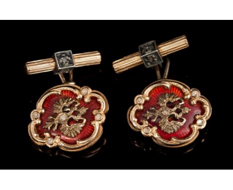 Pair Russian gold and enamel cufflinks with double-head eagle design on red guilloche enamel ground within gold scroll cartou