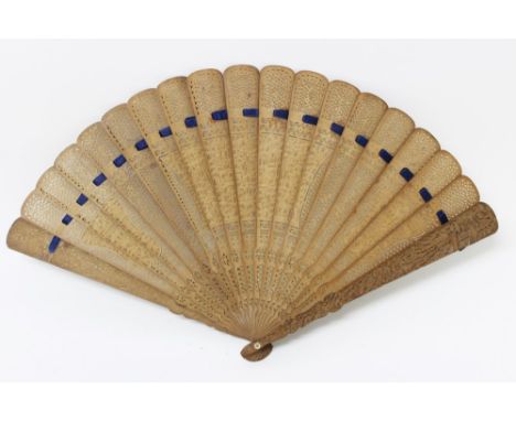 19th century Chinese Canton carved boxwood fan, finely relief carved and pierced with reserves of figures and pagodas within 