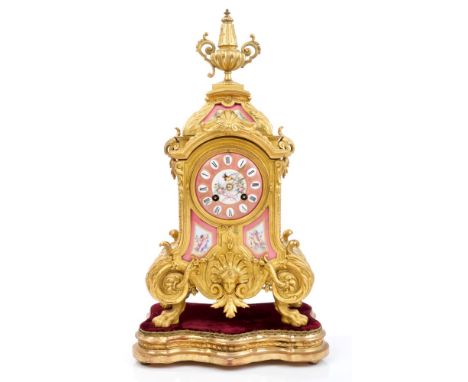 Late 19th century French gilt metal and porcelain cased mantel clock with urn finial and wreath and scroll decoration, pink p